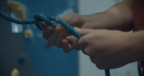 Man Tying Himself Into A Harness In Slow Motion 스톡 동영상 105917486