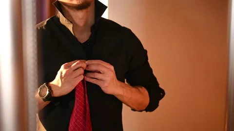 A man tying his red neck tie Stock Footage 146103663