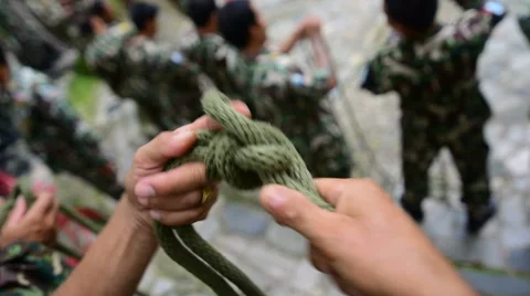 Man tying a knot Stock Footage 64934322