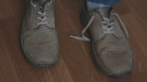 Man tying old shoes. Close up Stock Footage 102497406