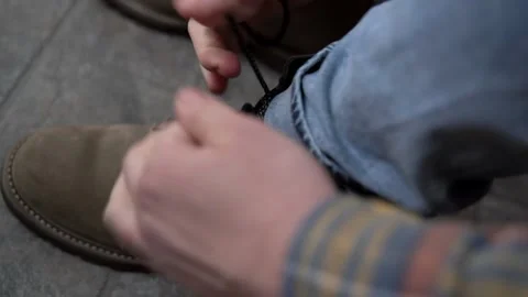Man tying shoelace on boot Stock Footage 160738701