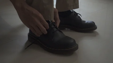 Man Tying Shoelace On Boots Stock Footage