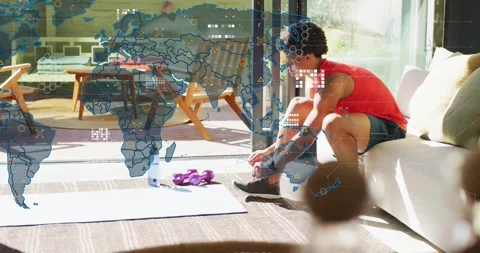 Man tying shoelaces on mat preparing workout as transparent world map layer Stock Footage 317834989