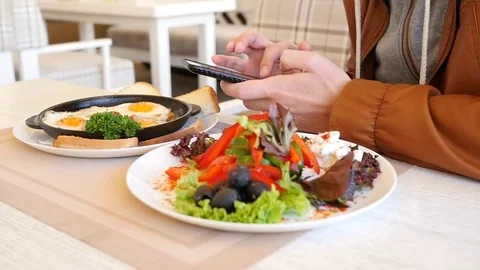 Man type slide his mobile smartphone during restaurant breakfast slow motion Stock Footage 74735705
