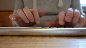 Man types on bluetooth keyboard in cafe Stock Footage 85568028