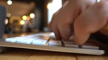 Man types on bluetooth keyboard in cafe Stock Footage 85568774