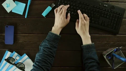 A man types on a computer keyboard on his desk and thinks. Stock Footage 82001546
