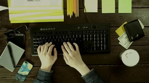 A man types on a computer keyboard on his desk. Stock Footage 82009580