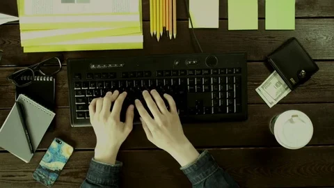 A man types on a computer keyboard on his desk. Stock Footage 82009770