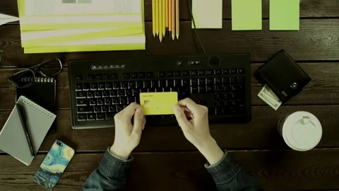 A man types on a computer keyboard on his desk. Stock Footage 82010604