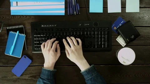 A man types on a computer keyboard on his desk. Stock Footage 82013449
