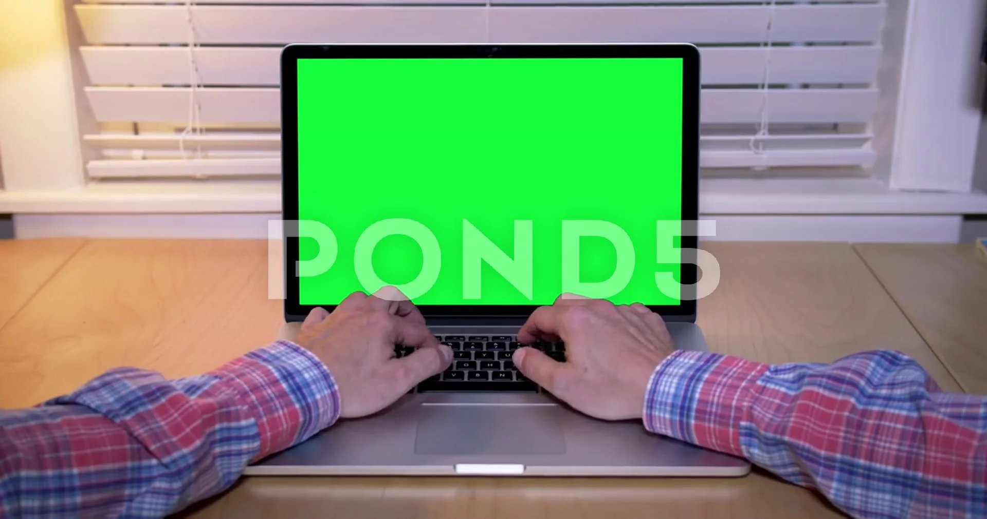 Man Types on Green Screen Laptop in 