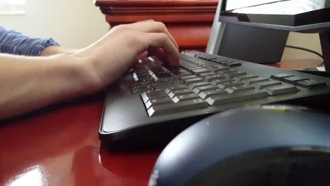 Man types on a keyboard Stock Footage 73946497