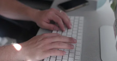 Man types on keyboard in home office Video stock 78037128