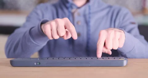 Man types on keyboard only with index fingers. Front view, blue-red flashing 動画素材 237742424