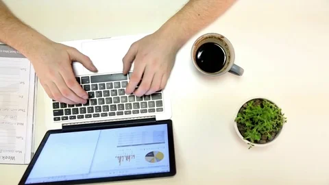 Man types on laptop and writes down notes Stock Footage 72312131