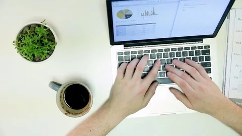Man types on laptop and writes down notes Stock Footage 72312132