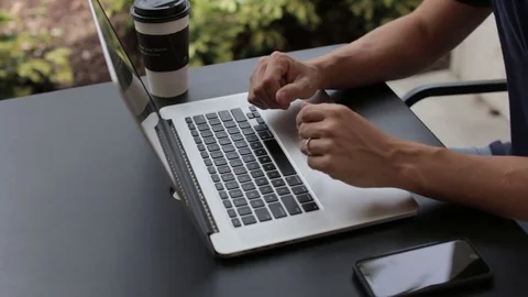 Man Types on Laptop Computer while Working Stock Footage 76484161