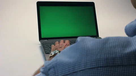 MAN TYPES ON A LAPTOP WITH GREENSCREEN Stock Footage 35349648