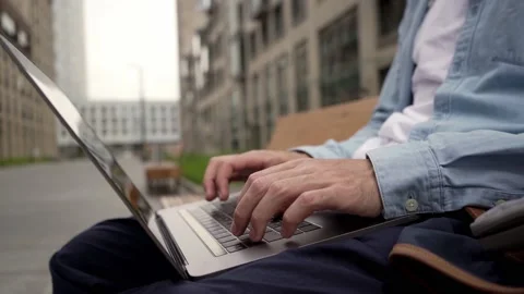 A man types on a laptop keyboard a message and surfs the space of the Internet.  Stock Footage 135108043