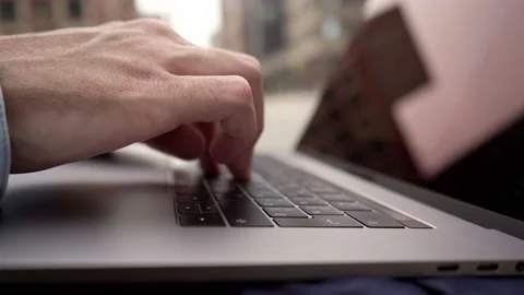 A man types on a laptop keyboard a message and surfs the space of the Internet.  Stock Footage 135108081