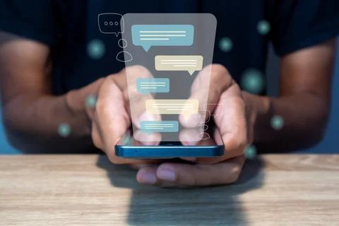 A  man types a message on a smart phone. Chatting, communication, dialog, c.. Stock Photos