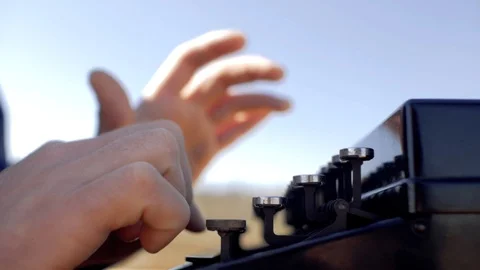 Man types on an old typewriter in nature. male hands press the typewriter keys Stock Footage 104898487
