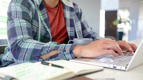 Man typing after keyboard touch, producing green numeric overlay while analyzing Stock Footage 334013800