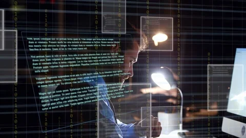 Man typing and clicking under desk lamp, causing HUD overlays surrounding head Stock Footage 333145025