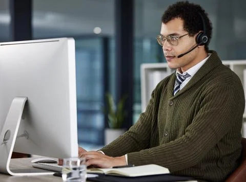 Man, typing and computer with headset in office for call center, customer with 스톡 사진