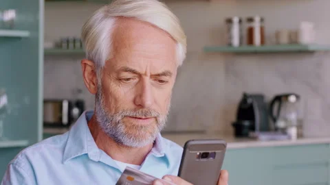 Man, typing and credit card in home with phone, search website and purchase for Stock Footage 332477523