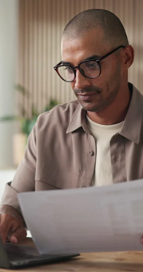 Man, typing and document in office with laptop, review or report insight for Stock Footage 334098571