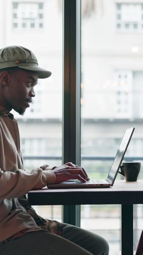 Man, typing and remote work in cafe with laptop, copywriting proposal and Stock Footage 336707792