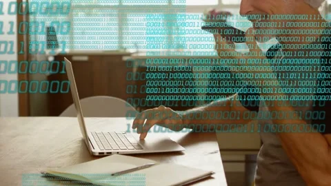 Man typing and speaking into phone for tech work, causing binary overlay to Stock Footage 332901923