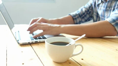 Man typing and working on a notebook with hands and Drinking black coffee. Stock Footage 96324620