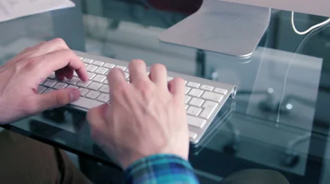 Man typing in an Apple  keyboard. Stock Footage 39992600