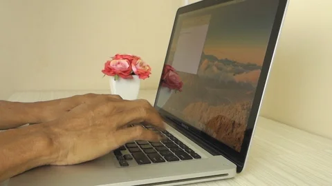 Man typing on Apple MacBook Pro laptop computer Stock Footage 114649164
