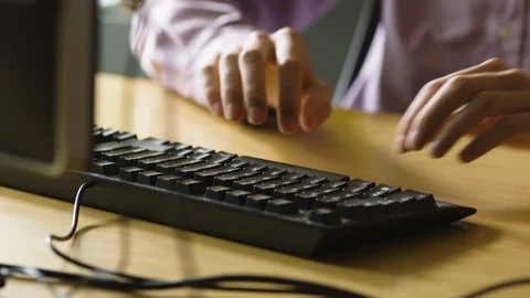 Man typing on black desktop keyboard Stock Footage 123882532