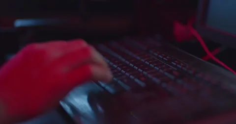 Man typing on a black keyboard at night Stock Footage 249496055