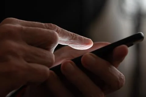 Man typing on a black smartphone 写真素材