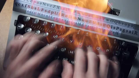 A man typing on a burning typewriter Stock Footage 175722566