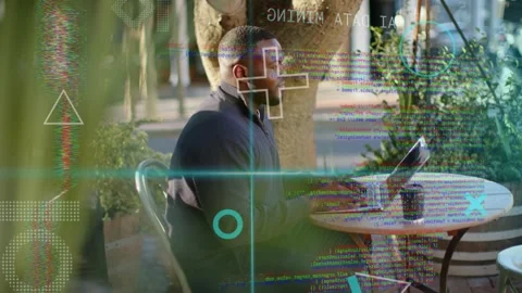 Man typing at cafe table, holographic HUD appearing and animating laptop data Stock Footage 334703311