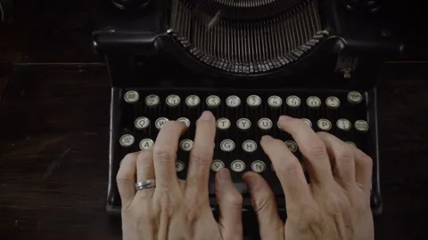 Man Typing on a Classical Typewriter Stock Footage 259415460