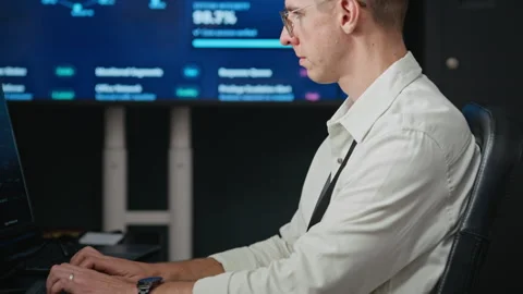 Man Typing on Computer in Cybersecurity Operations Center Stock Footage 346816557