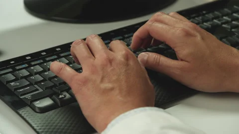 Man typing at computer Stock Footage 146362982