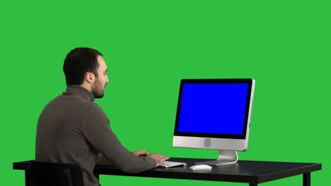 Man typing on the computer on a Green Screen, Chroma Key. Blue Screen Mock-up Stock Footage 99182529