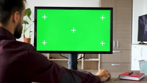 Man Typing on Computer With Green Screen Mockup in Home Living Room Stock Footage 330276225