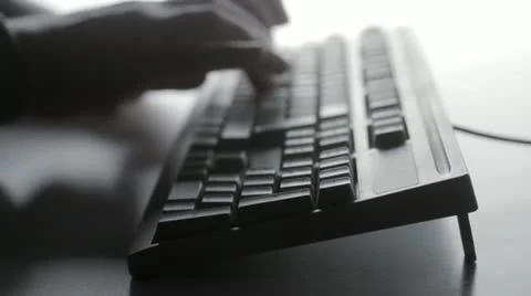 Man typing on computer keyboard Stockbeeldmateriaal 12992700