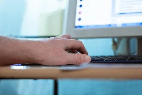 Man typing on computer keyboard with his left hand, remote work at home, Фото