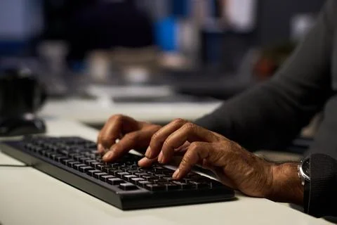 Man Typing on Computer Keyboard in Modern Cybersecurity Office Stock Photos